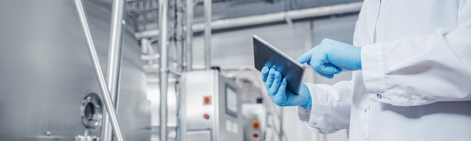 Technician on a tablet in a meat processing plant
