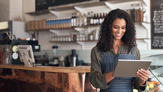 Lady taking customer order in a coffee shop